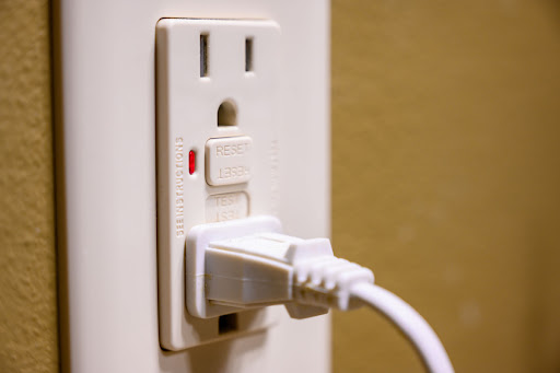 A GFCI outlet with a device plugged into it.