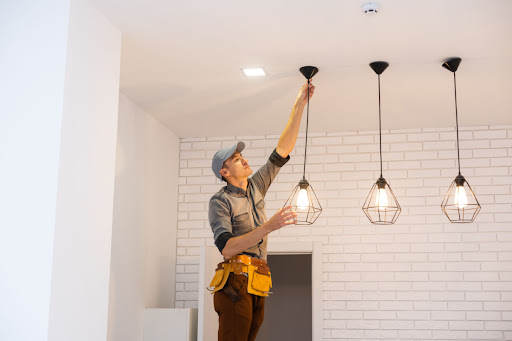 Staley electrician installing indoor lighting.